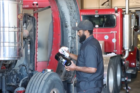 Mechanic performing preventative maintenance on fleet