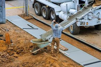 construction-worker-pour-cement-for-sidewalk