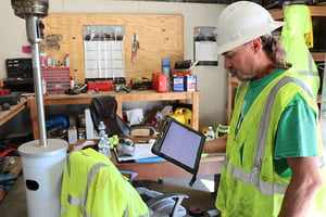 Mechanic Using the Tenna App to Track Maintenance Requests in the Shop